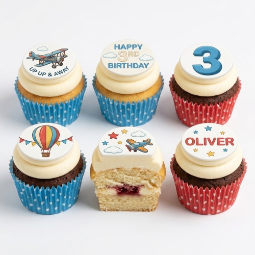 Set of six aeroplane and hot air balloon themed cupcakes with white frosting and blue and red polka dot cases.