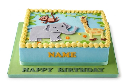 Rectangular blue and green jungle theme birthday cake with fondant elephant, giraffe, and monkey.