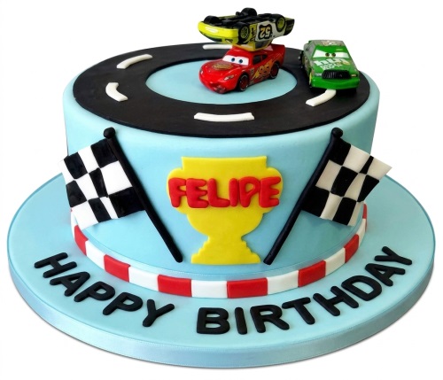 Light blue racing car birthday cake with Lightning McQueen, other race cars, track, flags, and a trophy.