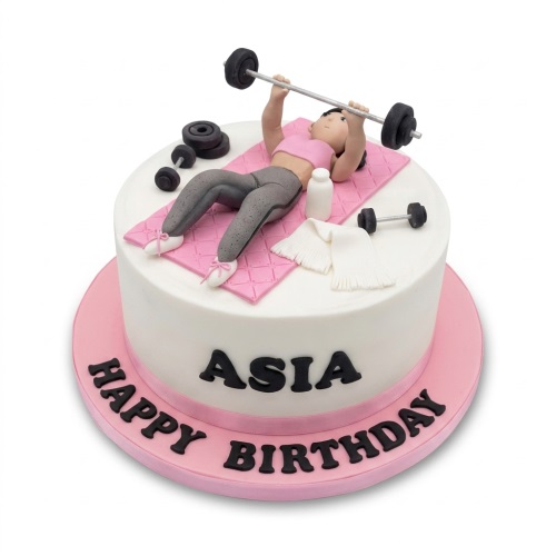 Round white cake with a female figure lifting weights on a pink mat, dumbbells, and a personalised birthday message.