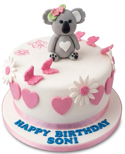 White round birthday cake with a grey koala, pink butterflies, hearts, and custom message.