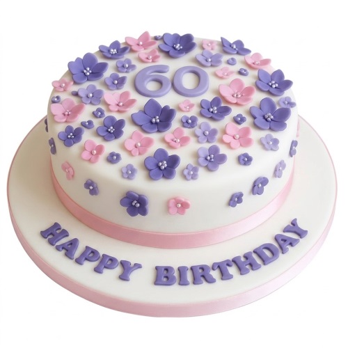 Round white birthday cake with pink and purple flowers, custom age topper, and Happy Birthday message.