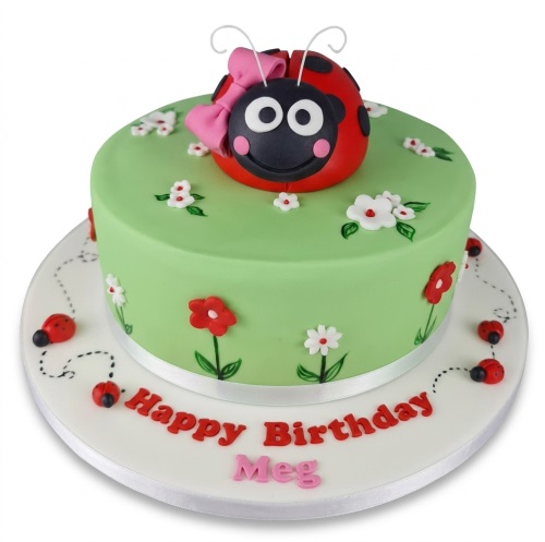 Round green ladybug birthday cake with a 3D ladybug topper, pink bow, and white and red fondant flowers.