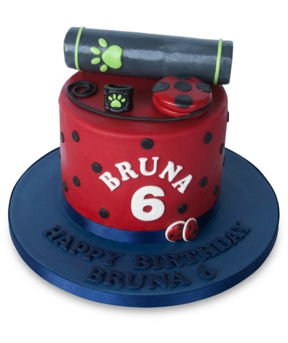 Red and black polka dot Miraculous Ladybug and Cat Noir themed birthday cake with custom age and name.