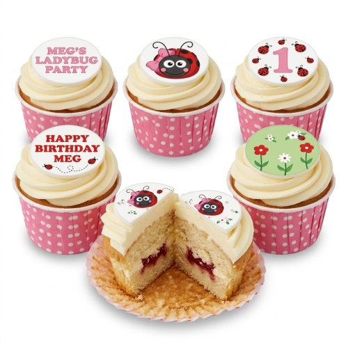 Cupcakes with white frosting and pink polka dot wrappers, decorated with ladybug and floral edible toppers.