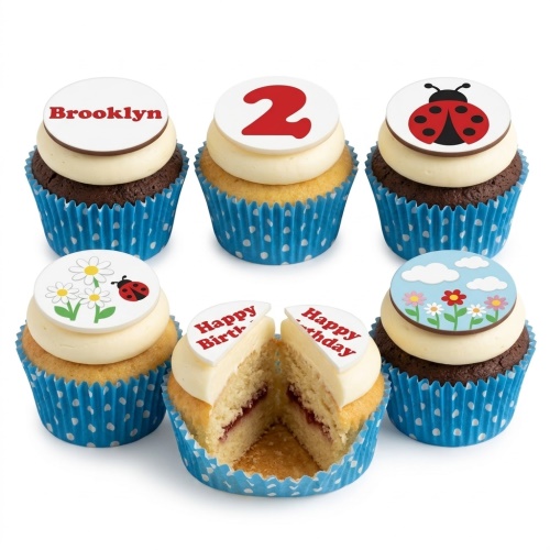 Set of six cupcakes with ladybug, flowers, clouds, custom name, and custom age '2' toppers in blue polka dot wrappers.