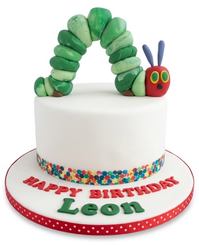 White single-tier cake with a 3D edible green and red Very Hungry Caterpillar on top, and a colourful sprinkle band around the base.