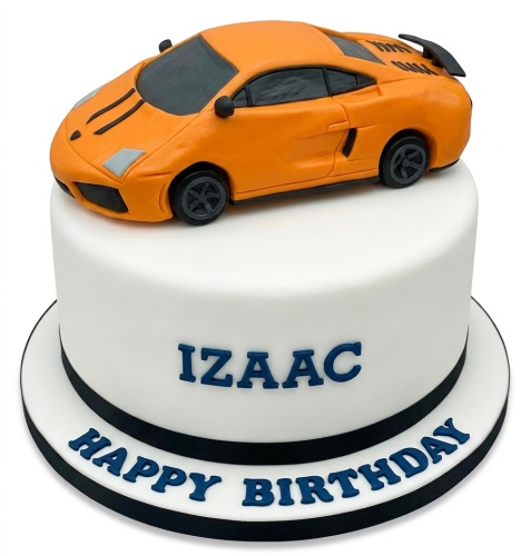 White birthday cake with orange sports car topper and personalised message.