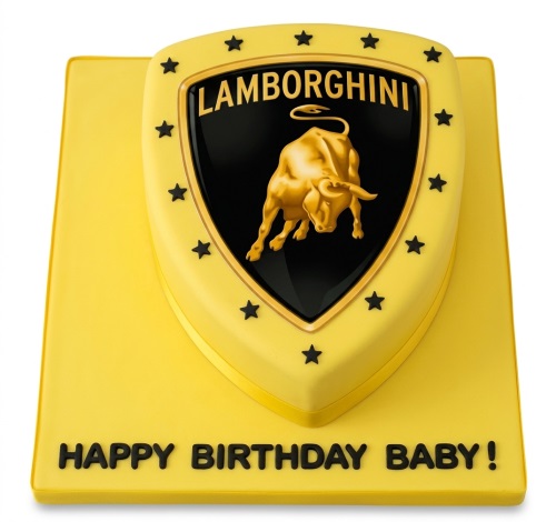 Yellow shield-shaped cake with black and gold Lamborghini logo on a yellow base with 'Happy Birthday Baby!' message.