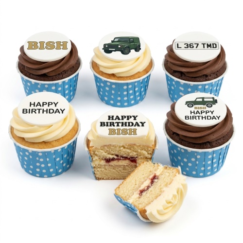 A set of chocolate and vanilla cupcakes with blue polka dot cases, topped with edible discs featuring a green Land Rover vehicle, a personalised name 'BISH', a registration plate 'L 367 TMD', and 'Happy Birthday' messages.