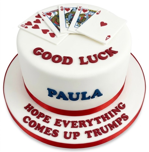 White round cake with edible playing cards and "Good Luck" message