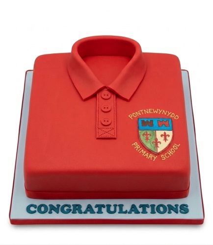 Red polo shirt cake with a school crest and 'Congratulations' message on the cake board.
