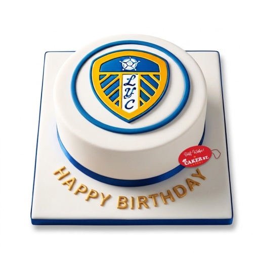 White round Leeds United football birthday cake with blue and gold club crest and "Happy Birthday" message.