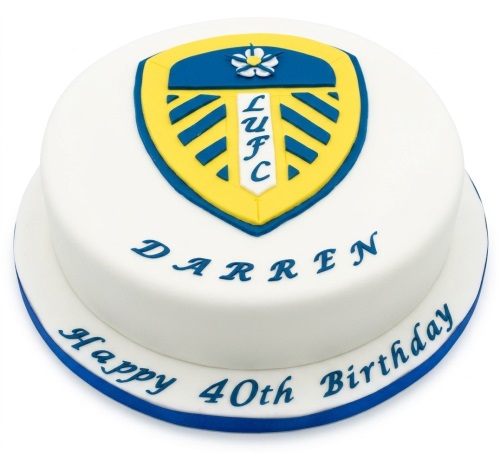 Round white birthday cake with Leeds United FC crest, personalised with a custom name and age.