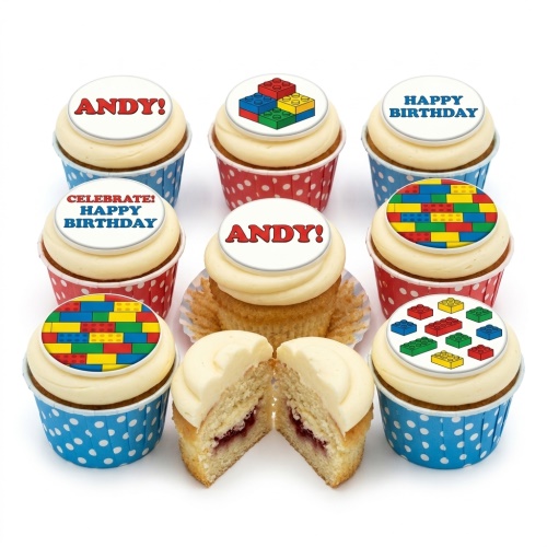 Cupcakes with white frosting and edible building block toppers, some with 'Happy Birthday' and a custom name.