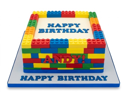 Rectangular birthday cake decorated with colourful building blocks and 'Happy Birthday' message.