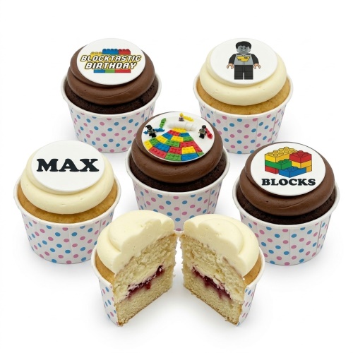 A selection of vanilla and chocolate cupcakes with building block themed edible toppers and polka dot wrappers.