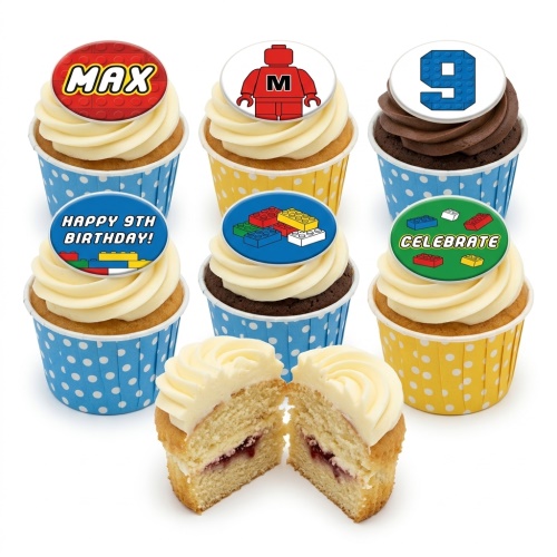 Cupcakes with colourful building block themed edible toppers, including a red block figure, assorted bricks, and a number 9.