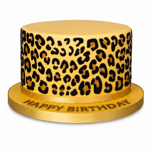 Round single-tier cake with yellow fondant and black and gold leopard print spots, on a gold cake board with 'Happy Birthday' message.