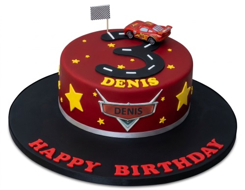 Red Lightning McQueen car birthday cake with a number road, yellow stars, and a checkered flag.