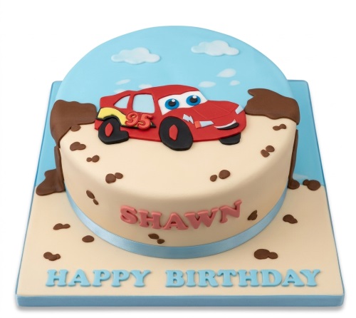 Round single-tier Lightning McQueen birthday cake with a red car, mud splatters, and a blue sky backdrop on a beige base.