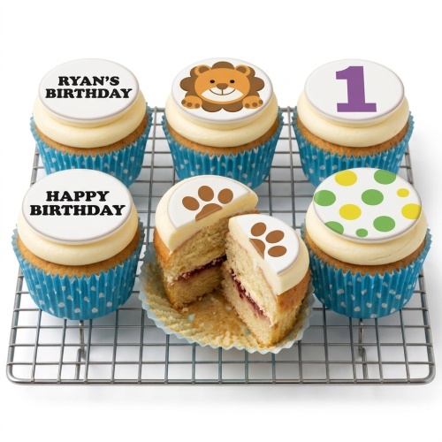 Jungle safari themed cupcakes with lion, paw print, and number 1 toppers in blue cases for a boy's first birthday.