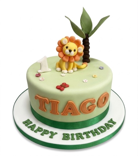 Round green fondant cake with a cute lion, palm tree, and custom age topper. Features a personalised name.