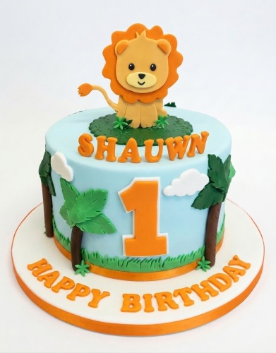 Cute fondant lion on a light blue jungle theme birthday cake with palm trees and custom age topper.