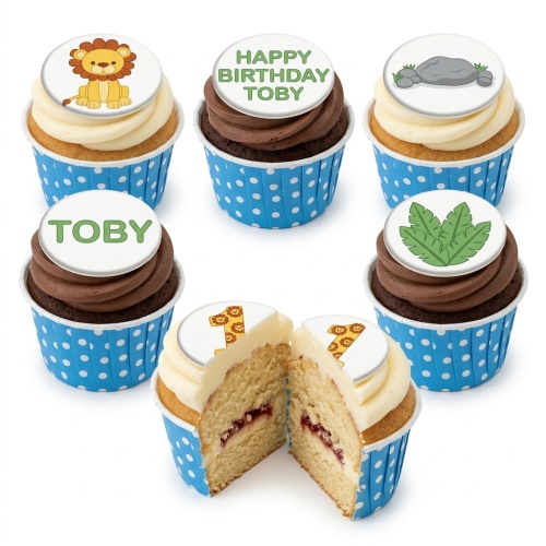 Vanilla and chocolate cupcakes with lion, leaves, rock, and custom age toppers in blue polka dot wrappers.