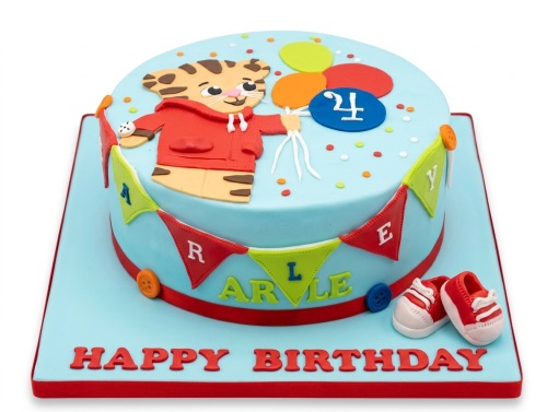 Round blue Daniel Tiger birthday cake with character cutout, balloons, custom age, bunting, and baby shoes.