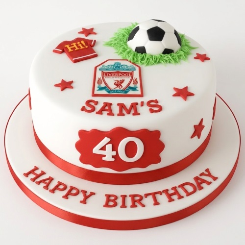 White fondant football birthday cake with Liverpool FC logo, football, red stars, and custom age plaque.