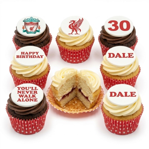 Selection of Liverpool FC themed cupcakes with red and white toppers, some with chocolate and some with vanilla frosting in red polka dot wrappers.