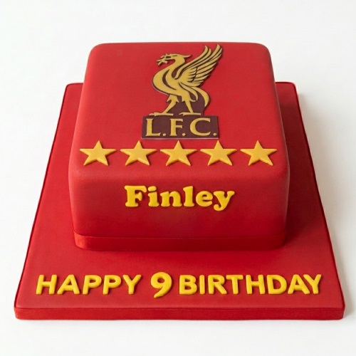 Red Liverpool FC football birthday cake with gold LFC logo, stars, and custom message.