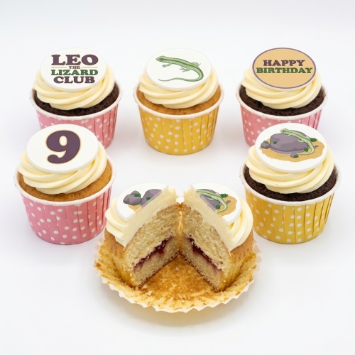 Assortment of lizard theme birthday cupcakes with custom age and "Happy Birthday" toppers.