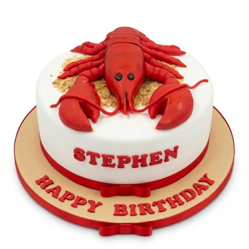 Round white birthday cake with a red lobster decoration and personalised message.