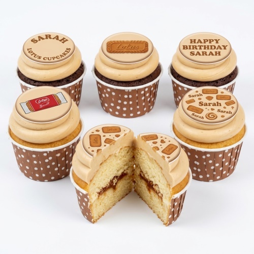 Set of six Lotus Biscoff cupcakes with caramel frosting and edible biscuit toppers, one cut open to show filling.