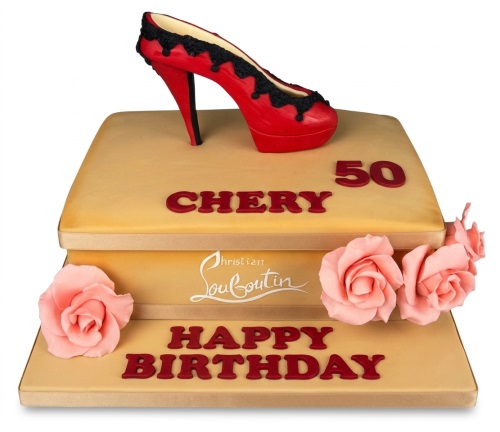 Two-tier golden-tan birthday cake with a red high heel shoe topper and pink sugar roses, with custom name and age.