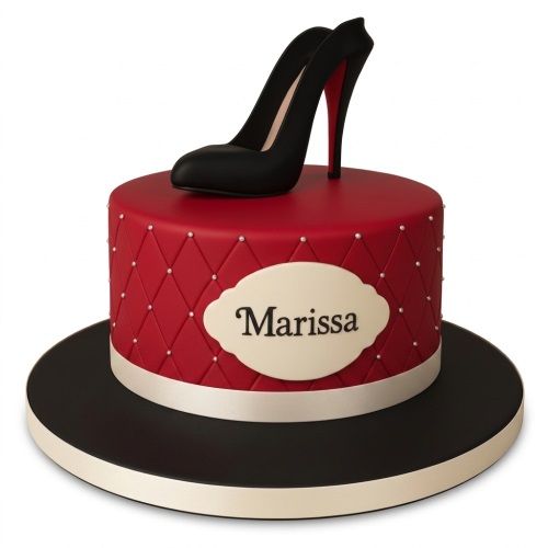 Round red birthday cake with a black high heel shoe topper and a personalised name plaque.