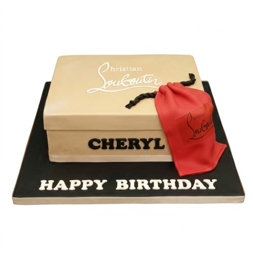 Beige luxury shoe box birthday cake with red dust bag, black cake board, and custom message.