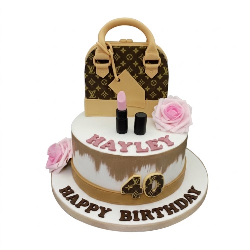 Two-tier designer handbag birthday cake with pink roses, lipstick, and a custom age topper.