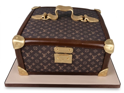 Brown luxury trunk cake with gold accents and LV monogram pattern
