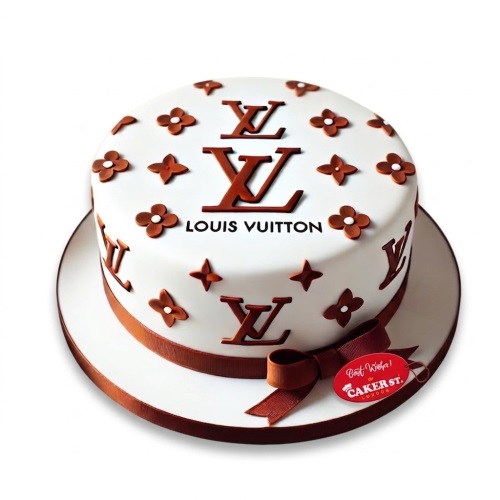 Round white cake with brown Louis Vuitton style logos and floral motifs, wrapped with a brown ribbon.