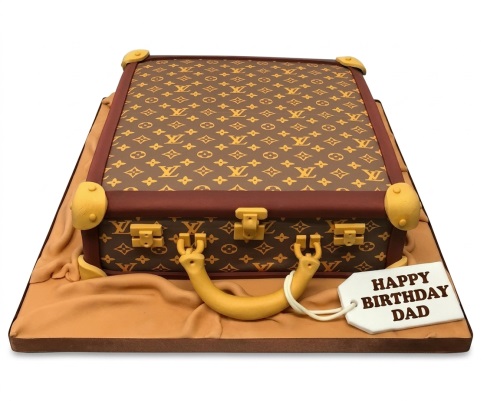 Brown suitcase cake with gold LV monogram and edible luggage tag