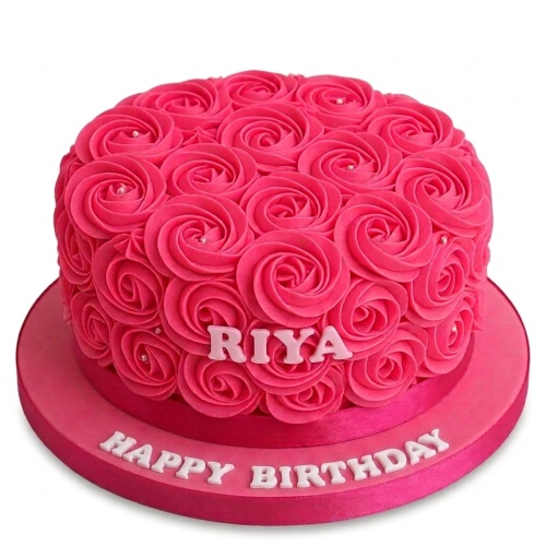Round pink buttercream rose birthday cake with a custom name and 'Happy Birthday' message.