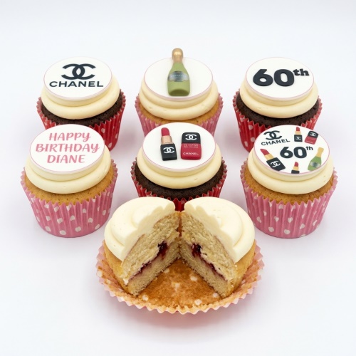 A selection of Chanel themed birthday cupcakes with lipstick, champagne bottle, and custom age toppers.