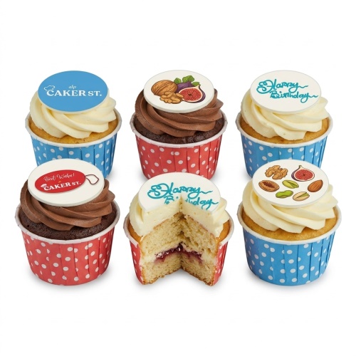 Selection of birthday cupcakes with 'Happy Birthday' messages and gourmet nut and fig toppers.