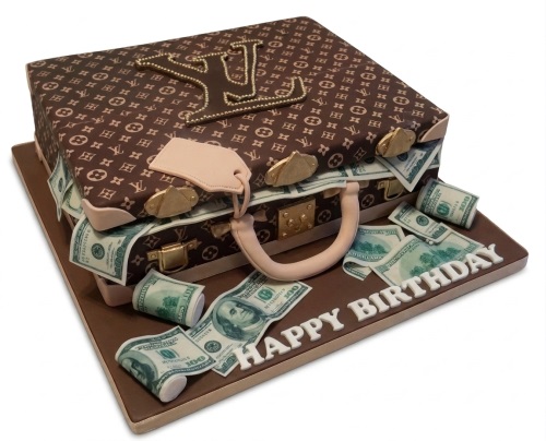 Brown suitcase birthday cake with LV logo and edible dollar bills
