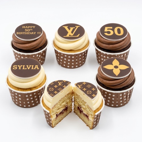 Cupcakes with brown and cream frosting, topped with Louis Vuitton style logos and custom birthday messages.