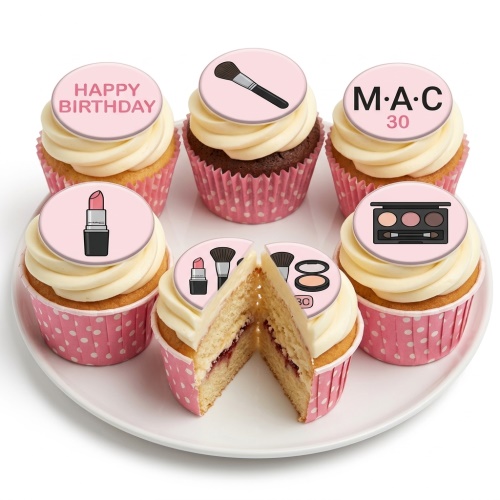 A selection of cupcakes with pink and white polka dot cases and cream icing. Toppers feature lipstick, makeup brush, eyeshadow palette, and 'Happy Birthday' message.