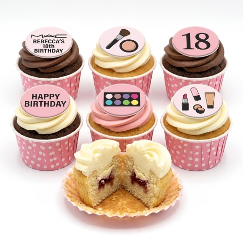 A selection of makeup themed birthday cupcakes with pink and brown frosting, in pink polka dot cases, with custom age and happy birthday toppers.